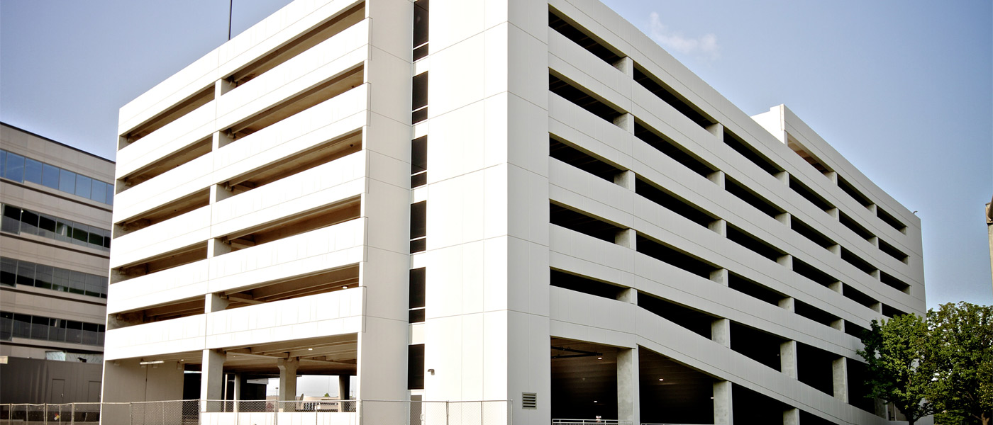 A large white parking deck built with precast concrete components. 